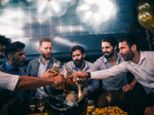 a group of guys enjoying a night out with drinks